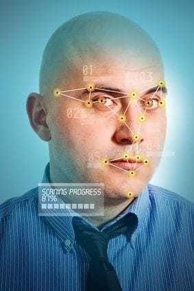 Face detection software recognizing a face of young adult bald businessman.