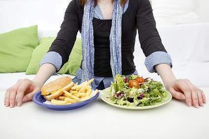Person choosing between salad or burger