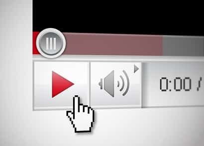 Finger poised on video play button