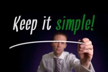 A businessman writing Keep It Simple on a screen. Business Concept.