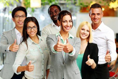 Happy business group giving thumbs up