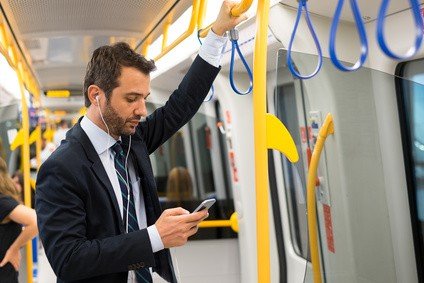 Man using phone on underground train